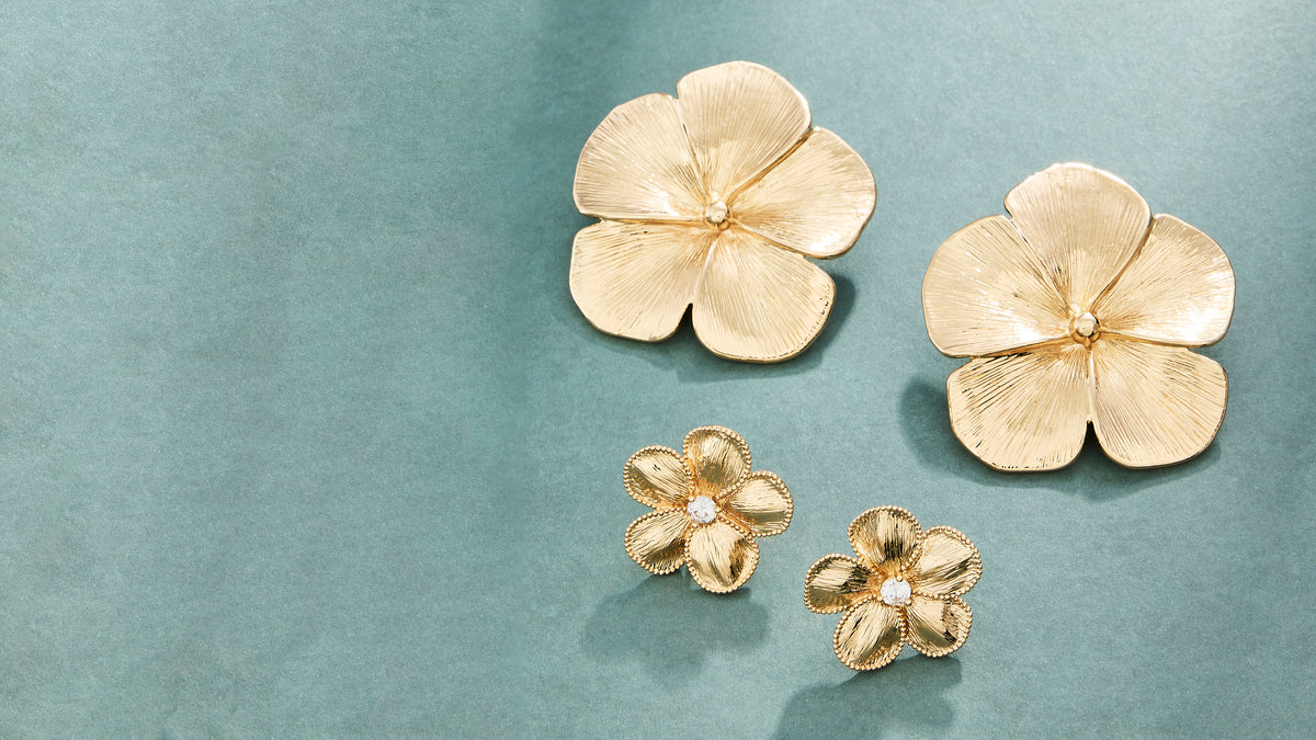 Flower earrings on a teal/blue background